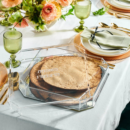 Decorative table setting with a matzah box tray and green glasses, and floral arrangements - AFH Bargains